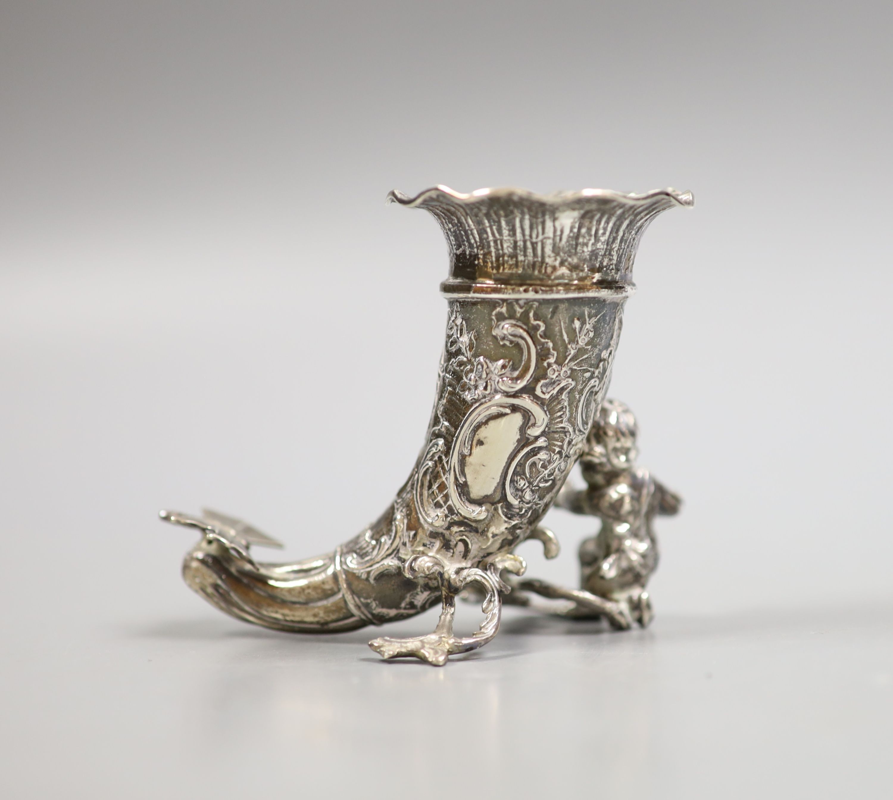 A late Victorian small silver cornucopia vase, with putto surmount, import marks for Thomas Glaser, London, 1893, height 75mm, 103 grams.